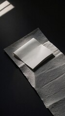 White Folded Paper with Strong Shadows on Dark Background