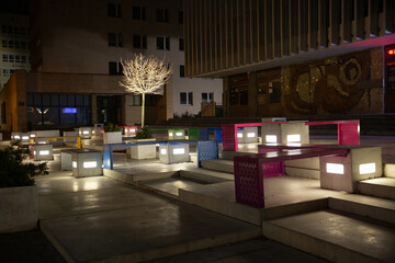Exploring the Beauty of Illuminated Urban Space at Night Featuring Colorful Furniture Designs