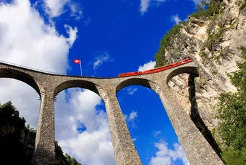 red train of Glacier Express on Viaduct Landwasserviadukt