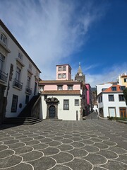 Traditional buildings and geometric stone paving in Funchal, capital of Madeira Island, Portugal. A vibrant Atlantic city with rich architectural heritage.