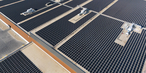 Solar panels on a roof of industrial building. Aerial view