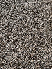 Natural stone pebble concrete surface with rough texture seen