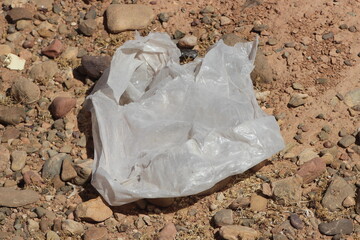 A plastic bag on the ground, Plastic environmental impact