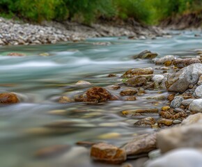Gentle stream flows over rocks along the shore of river Isar in Alps