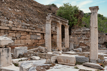 Fototapeta premium Ancient Roman ruins with marble columns and stone walls at the archaeological site of Ephesus, Selcuk, Turkey