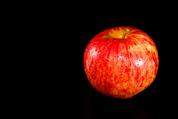 Apple isolated on black background closeup view copy space  
