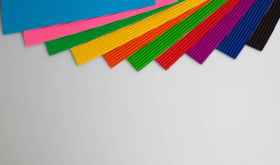 Background of colorful sheets of corrugated paper for classes with children, with a place for your text