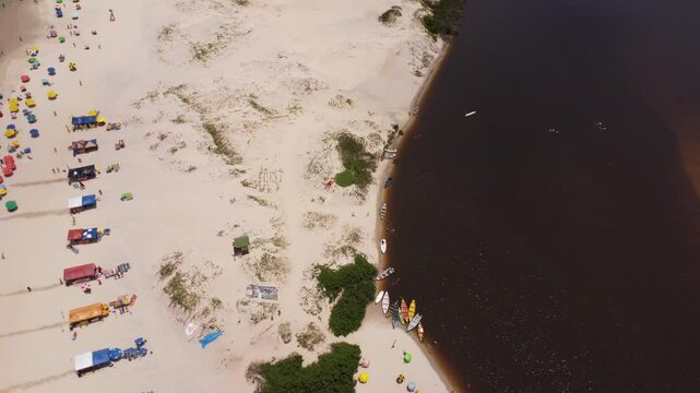4K Drone Pullback Over Guarda do Emba&uacute; Beach with Tourists and River Mouth