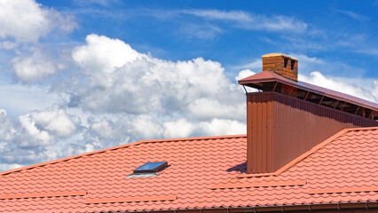 house with a roof from a red shingles with a pipe