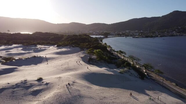 4K Drone Pullback Over Dunes and Lagoon at Sunset in Lagoa da Concei&ccedil;&atilde;o, Brazil