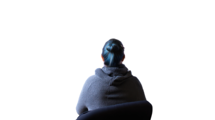 Person with blue hair sitting in a chair, facing away, isolated background.