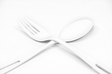 Spoon and fork together on white background close-up view 