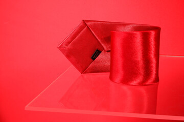 Silky smooth red tie rolled up closeup shot, tie macro photography 