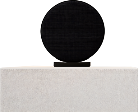 A modern speaker on a white textured surface black backdrop