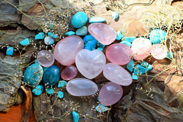 Beautiful natural stones of pink quartz and turquoise on a wooden background. Healing crystals. Predictions and magic.