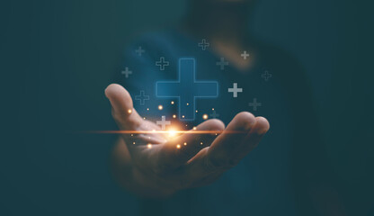Businessman holding virtual plus sign for positive thinking mindset or healthcare insurance concept. Mental health care, mental rejuvenation.