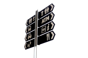 Directional signboards with arrows pointing to various destinations, mounted on a pole,...