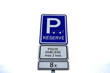 Electric vehicle parking sign indicating a designated spot for eco-friendly cars. A symbol of modern mobility, clean energy, and sustainable urban transport.

