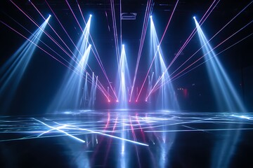 Blue and purple laser beams create an illuminated pattern on a reflective stage surface