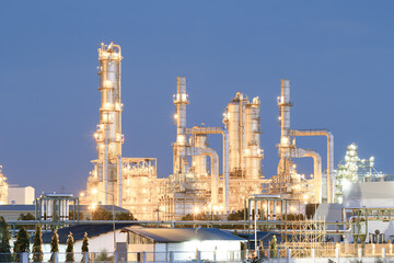 Oil gas refinery plant at night blue sky background in Map Ta Phut Industrial Estate, Thailand. May called petrochemical plant. Processing plant to production gasoline fuel, power energy.