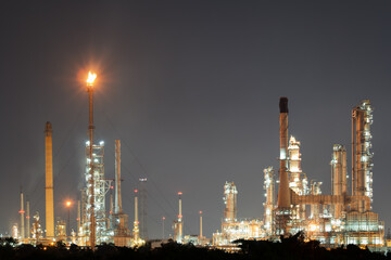 Oil gas refinery plant and gas flare or flare stack. Industrial factory construction from...
