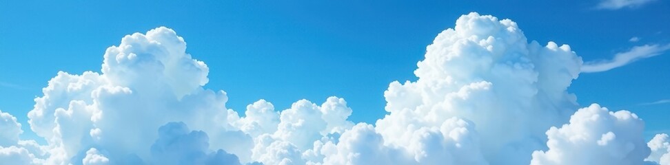 Vast, fluffy white clouds dominate a brilliant blue sky , light, serene