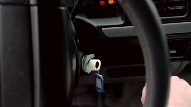 Inserting a key into the ignition to start the car.