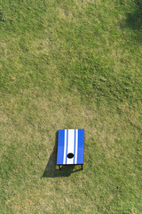Cornhole game set on green grass. Aerial high angle view