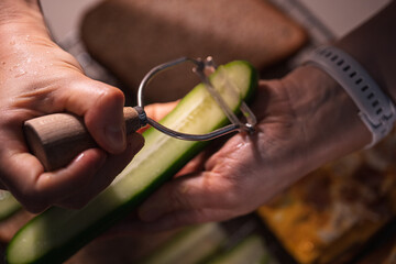 A Detailed Scene of Peeling a Cucumber