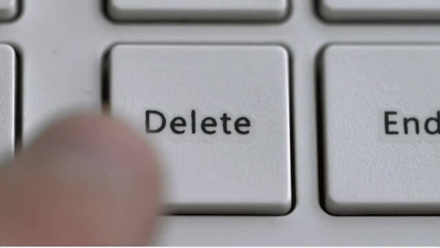 video of finger pressing delete file button on computer keyboard