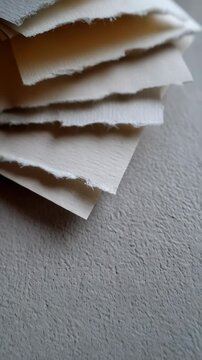 Close up of handmade paper stack with rough edges, art supplies texture and a grey background for creative projects and stationery design