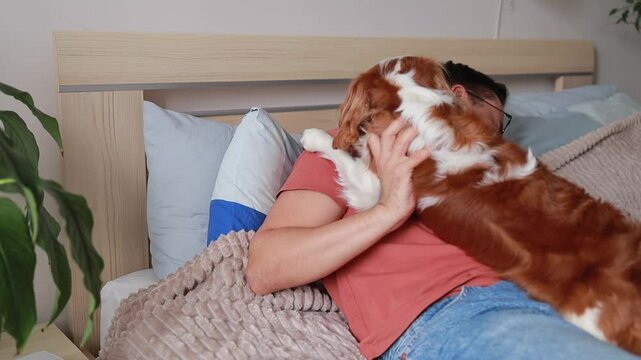 man petting dog and sneezing from allergy to fur and animals