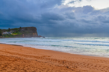 Moody sunrise with waves at the seaside