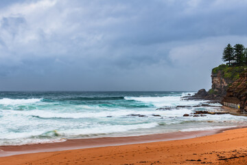 Moody sunrise with waves at the seaside
