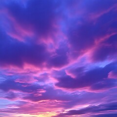 Fototapeta premium Vibrant sunset cloudscape. A captivating view of a dramatic sunset sky, filled with swirling, colorful clouds in shades of purple, pink, and blue. A warm golden hue suggests the sun's final rays