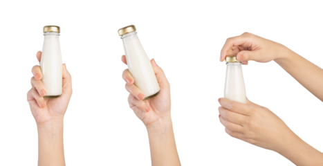Hand holding milk bottle on white background