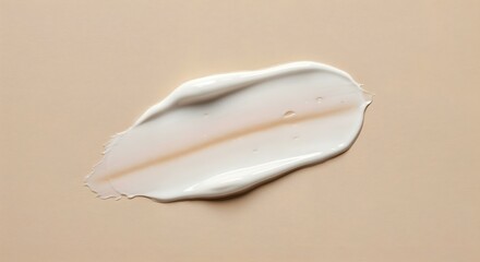 Creamy white texture on a beige surface, illustrating a cosmetic product for skin care and dermatological use