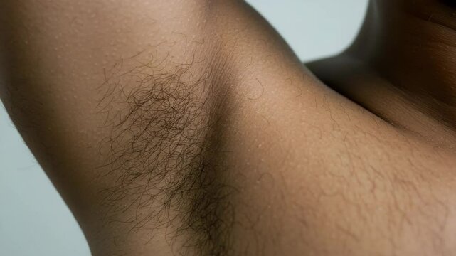 Close-up of human armpit showing hair and skin texture  