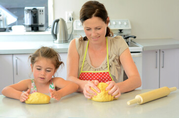 Mother and child kneading dough
