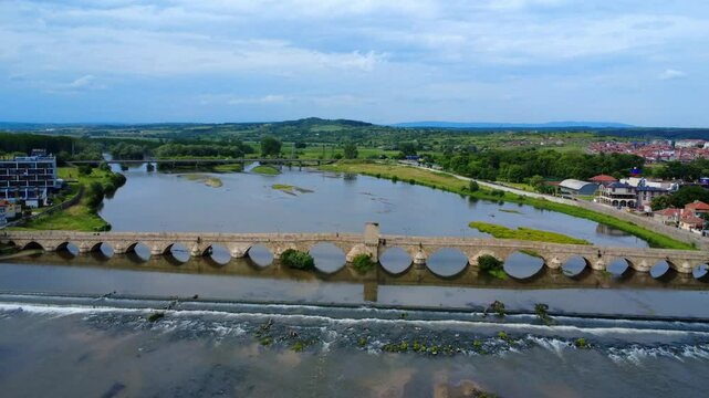 Aerial drone view of the Old Bridge in Svilengrad, Bulgaria. Built between 1512&ndash;1529, this historic Ottoman stone bridge spans the Maritsa River with graceful arches.
