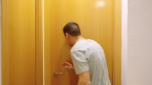 Impatient man waiting for the toilet to become available