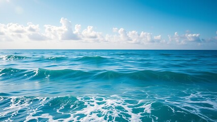 Obraz premium A picturesque view of a tranquil ocean scene under a vibrant blue sky with fluffy white clouds gently rolling across the horizon.