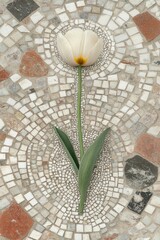 Cream tulip on ornate mosaic.  A single, pale cream tulip, with a yellow-orange center, rests on a decorative mosaic floor.  Green leaves and a long stem