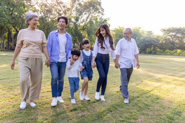 Happy Asian family walking in the park, Outdoor with big family and summer season concept