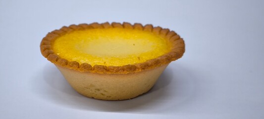 Egg tarts that are crispy on the outside and soft on the inside. Egg tarts that have a rich and creamy egg aroma. Egg tarts on white background.