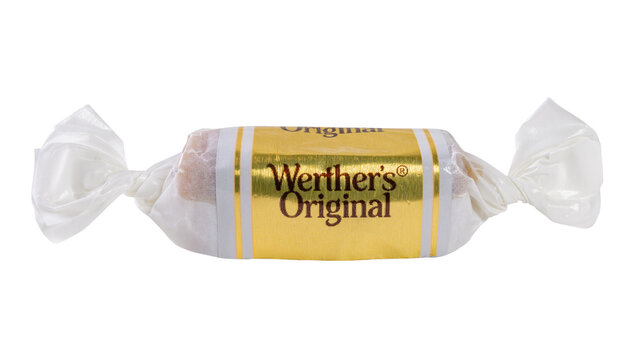A Werther's Original candy wrapped in gold and white foil, placed on a white clean background.