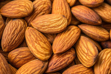 Fototapeta premium Organic raw peeled almond nuts as background, top view. Vegetarian snack or Healthy food concept