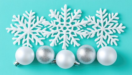 Three white snowflakes and four silver and white Christmas balls on a teal background