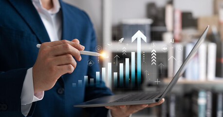 Businessman analyzing digital data on a laptop with AI-powered graph icons and growth arrows,...