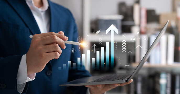 Businessman analyzing digital data on a laptop with AI-powered graph icons and growth arrows, representing business strategy, financial performance, and digital innovation.